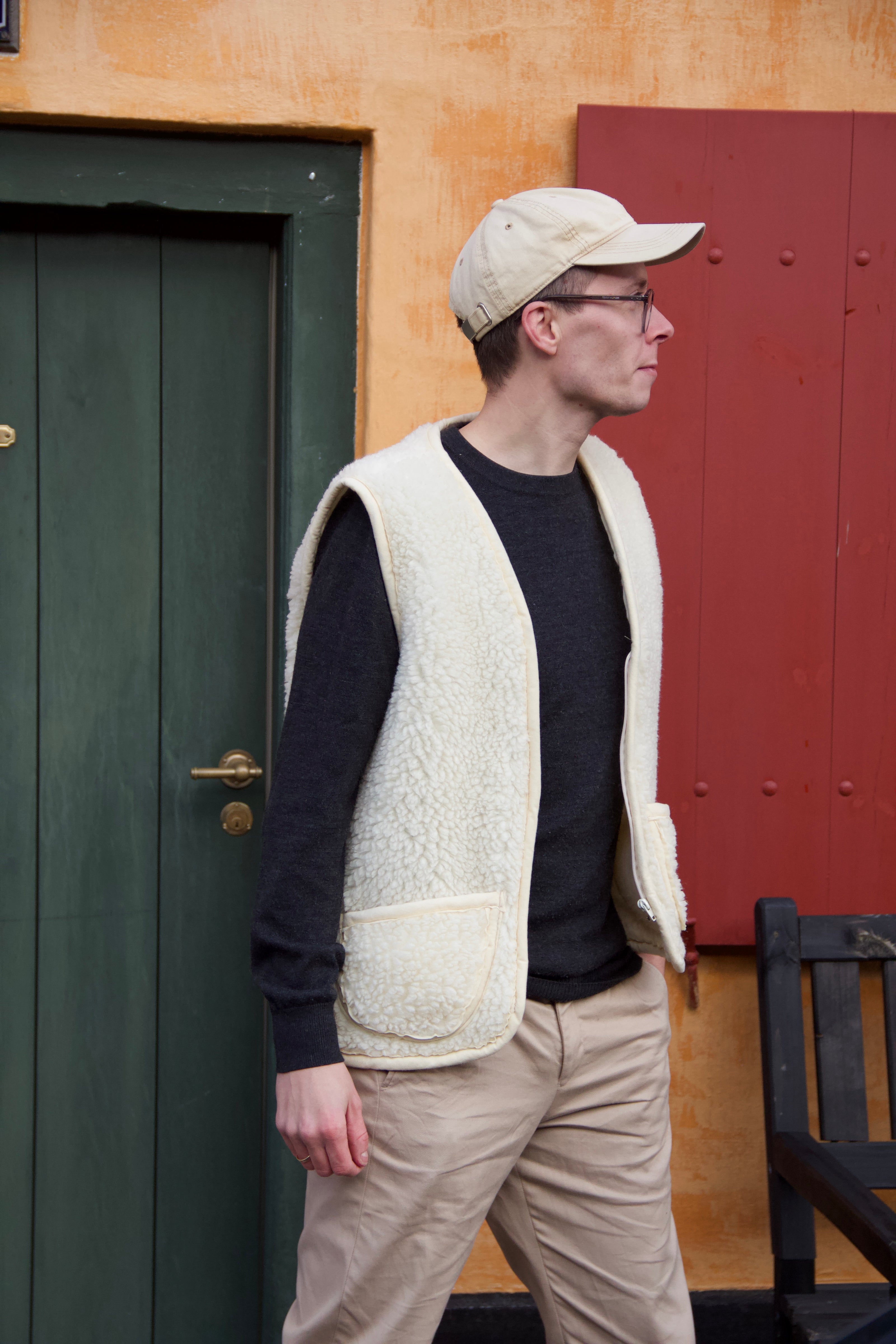 man wearing white merino wool fluffy cozy vest with pockets and zipper - scandinavian look